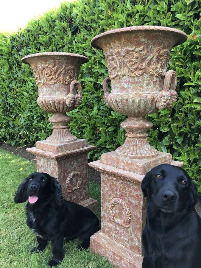 Pair of Cast iron campagna urns on plinths