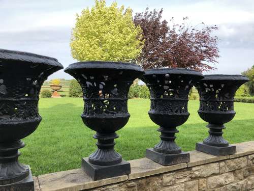 Pair cast iron urns pierced and foliate design