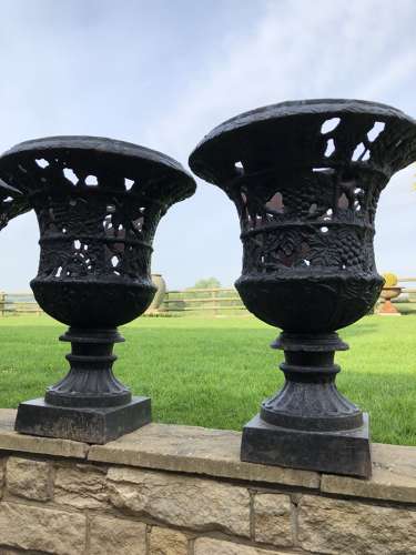 Pair cast iron urns pierced and foliate design