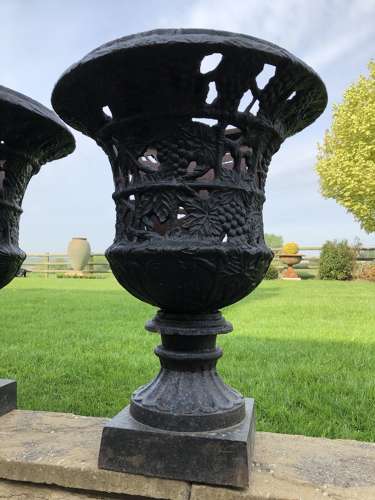 Pair cast iron urns pierced and foliate design