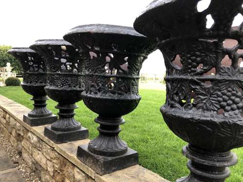 Pair cast iron urns pierced and foliate design