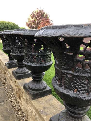 Pair cast iron urns pierced and foliate design