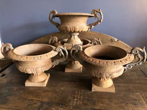 Set of four cast iron urns with handles