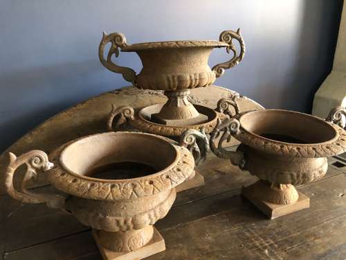 Set of four cast iron urns with handles