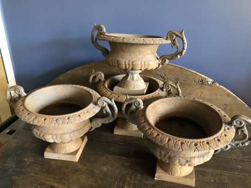Set of four cast iron urns with handles