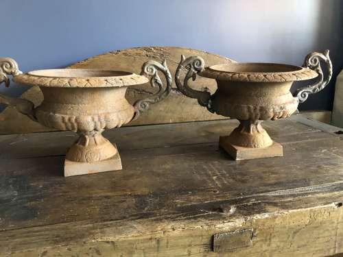 Set of four cast iron urns with handles