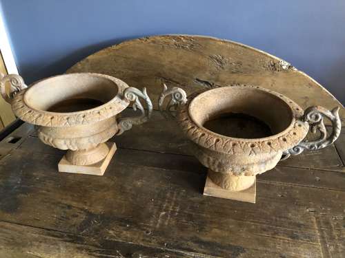 Set of four cast iron urns with handles