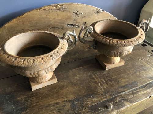 Set of four cast iron urns with handles
