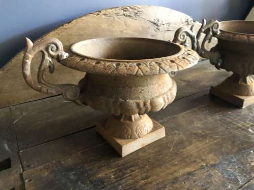 Set of four cast iron urns with handles