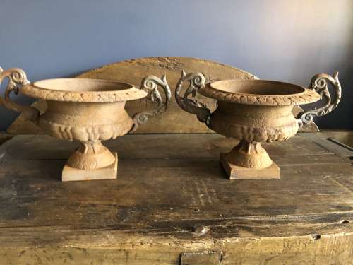 Set of four cast iron urns with handles