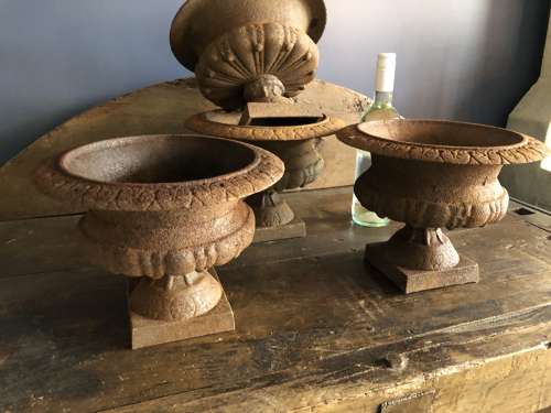 Set of four small Cast Iron Urns