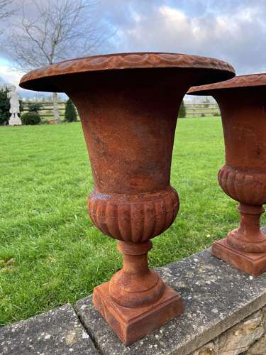 Pair of rusty cast iron urns - cast iron planters