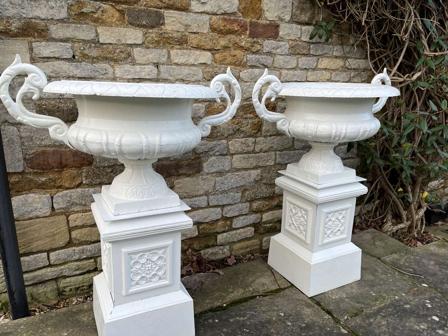 Pair of large cast iron urns & plinths