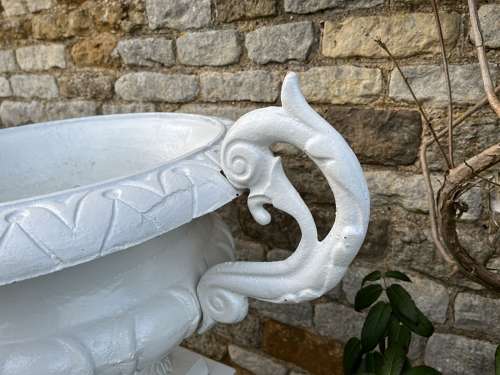 Pair of large cast iron urns & plinths