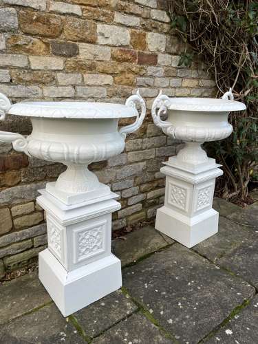 Pair of large cast iron urns & plinths