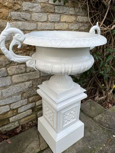 Pair of large cast iron urns & plinths