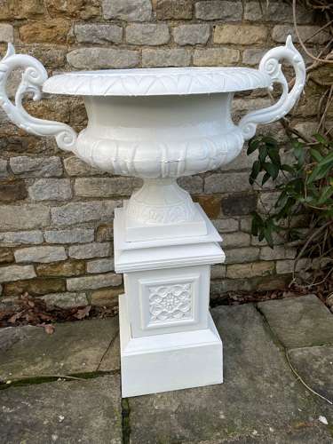 Pair of large cast iron urns & plinths