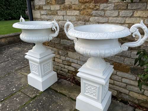 Pair of large cast iron urns & plinths