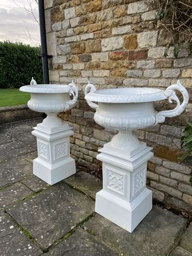 Pair of large cast iron urns & plinths