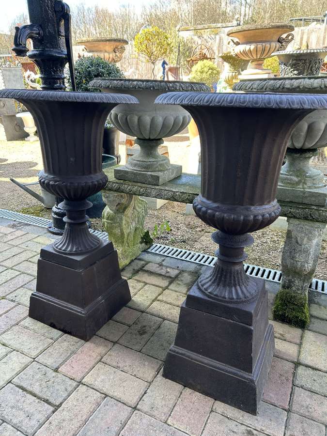 Pair of Brown Cast Iron Gadrooned Urns on Plinths
