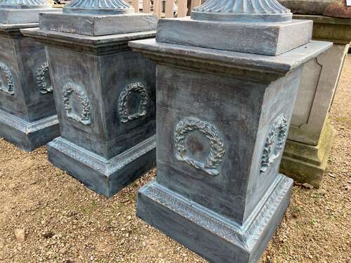 Large pair of cast iron urns and plinths