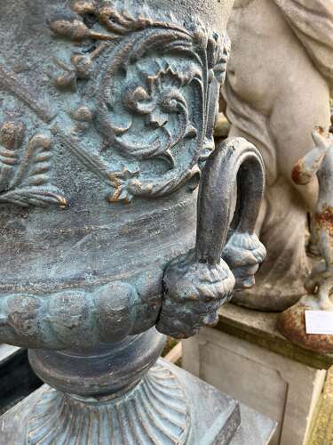 Large pair of cast iron urns and plinths