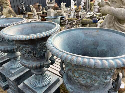 Large pair of cast iron urns and plinths