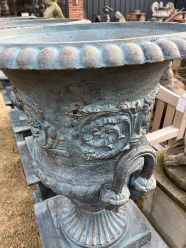 Large pair of cast iron urns and plinths