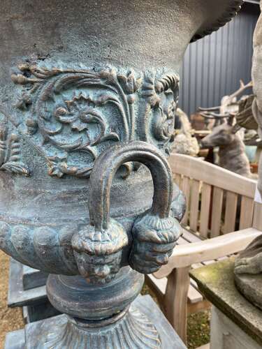 Large pair of cast iron urns and plinths