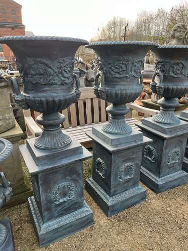 Large pair of cast iron urns and plinths