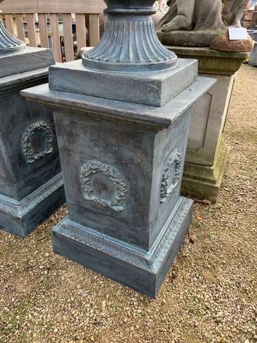 Large pair of cast iron urns and plinths