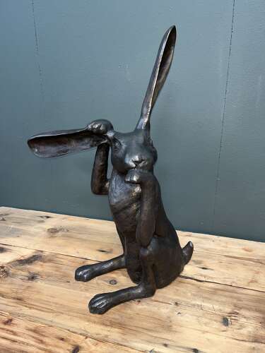 Hare sculpture - bronze hare touching ear.