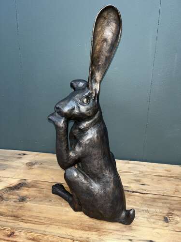 Hare sculpture - bronze hare touching ear.