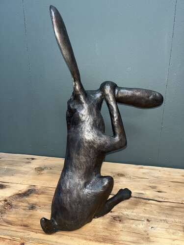 Hare sculpture - bronze hare touching ear.