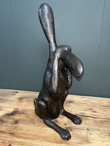 Hare sculpture - bronze hare touching ear.