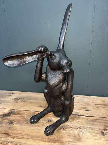 Hare sculpture - bronze hare touching ear.