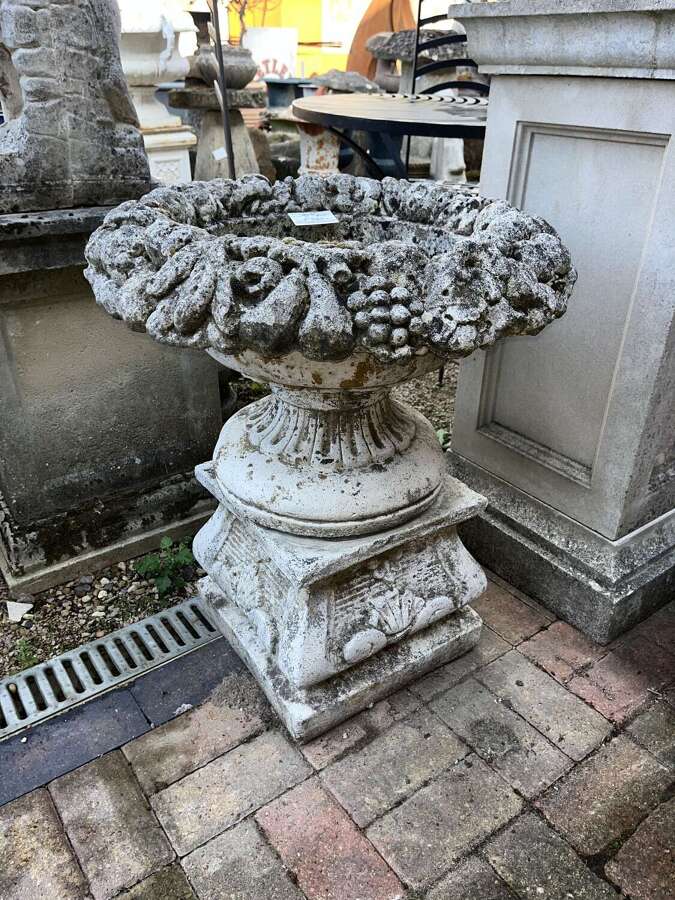Stone fruit basket planter on plinth