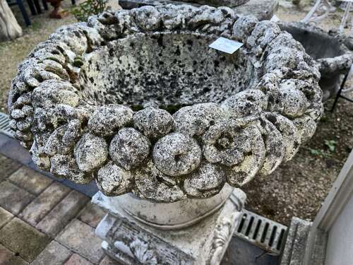 Stone fruit basket planter on plinth