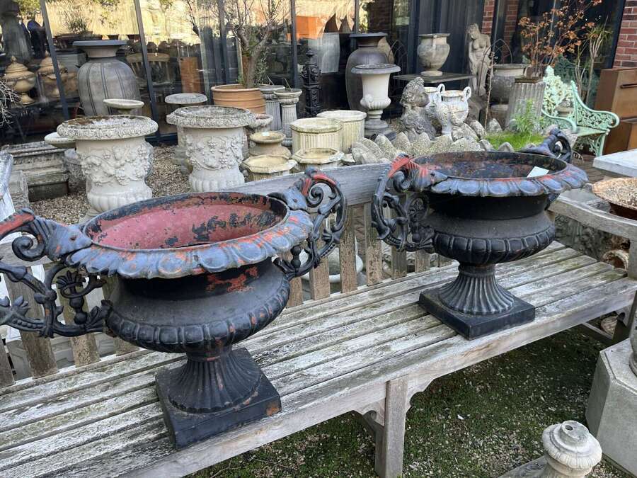 Pair of antique cast iron urns with handles