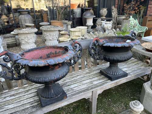 Pair of antique cast iron urns with handles